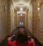 Danny and twin girls in hallway in Kubrick's The Shining